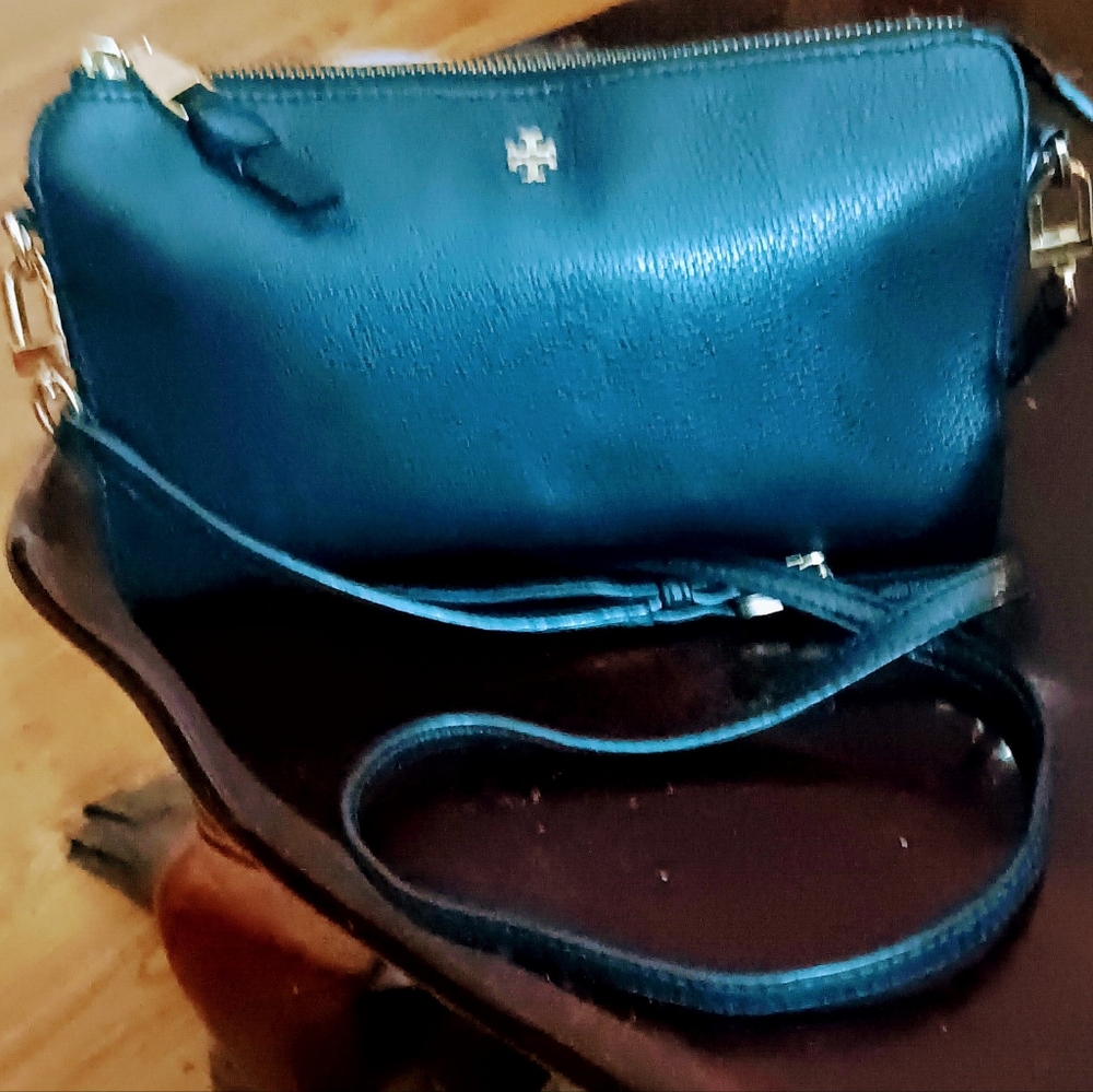 Tory Burch Black Leather Cross body Purse with brass buckle adjustable strap.